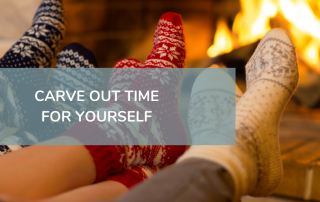 feet in festive socks by the fire